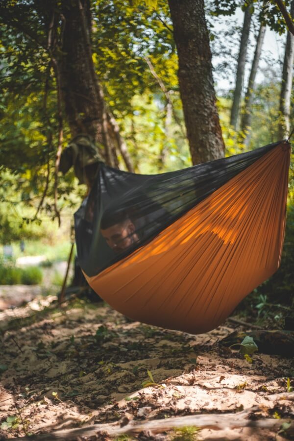 neefortrees hammock with integrated mosquito net, on the sand by the river bank in summer
