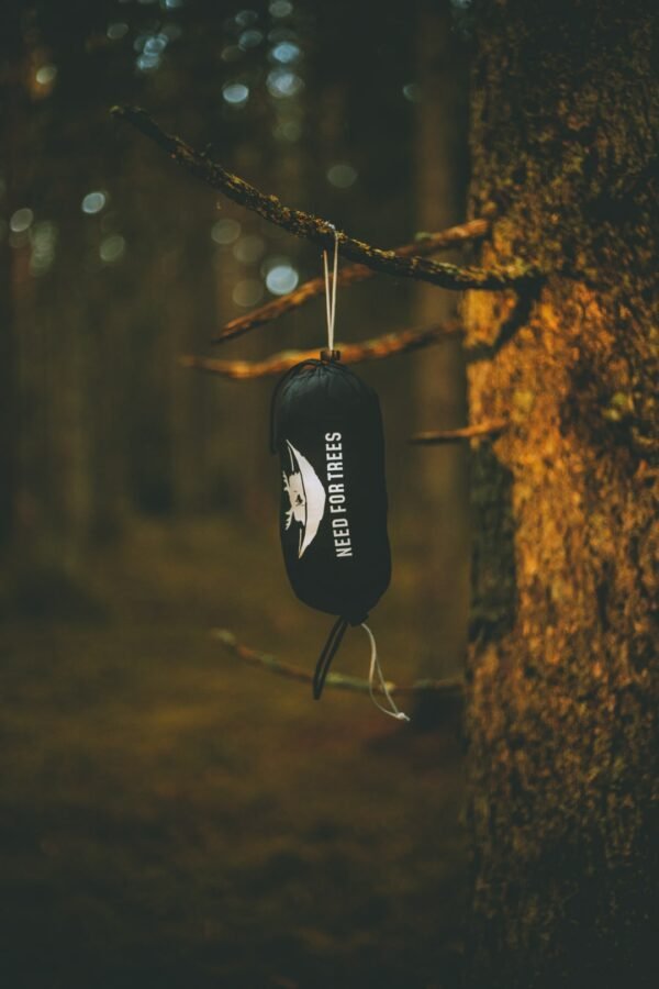 NFT black hammock bag with forest background, with packed hammock inside