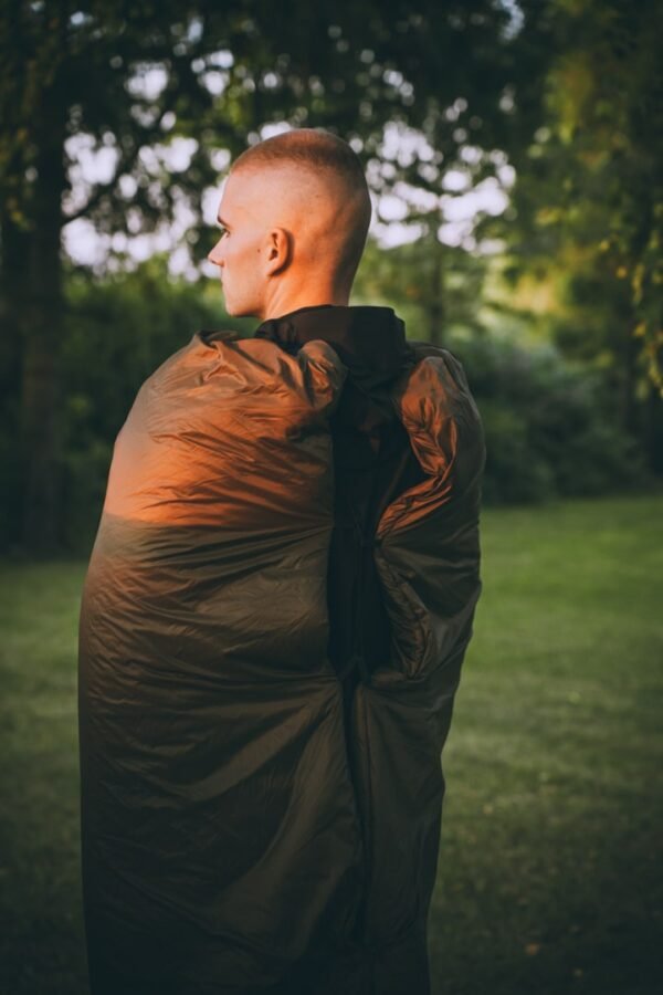 A person in a sleeping bag, standing up, showing what it looks like on the body