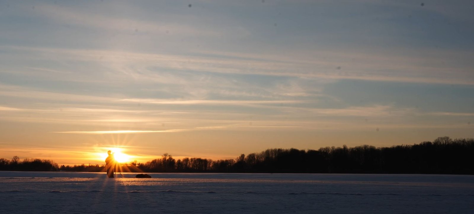 winter sunset with sleds